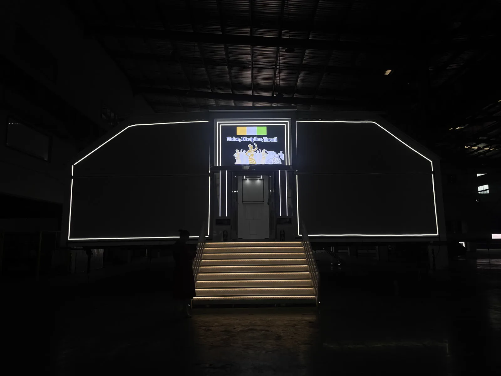 Semi-trailer expandable venue illuminated at night